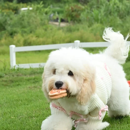 Crèmekleurige gebreide hondentrui met roze strikaccenten