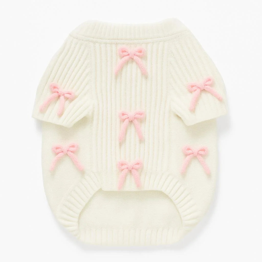 Crèmekleurige gebreide hondentrui met roze strikaccenten